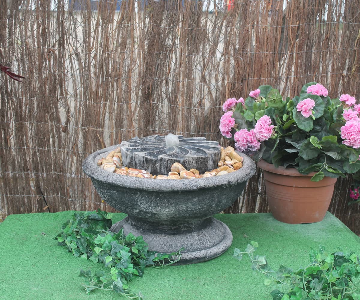 Patio fountain with millstone giving a gentle water sound